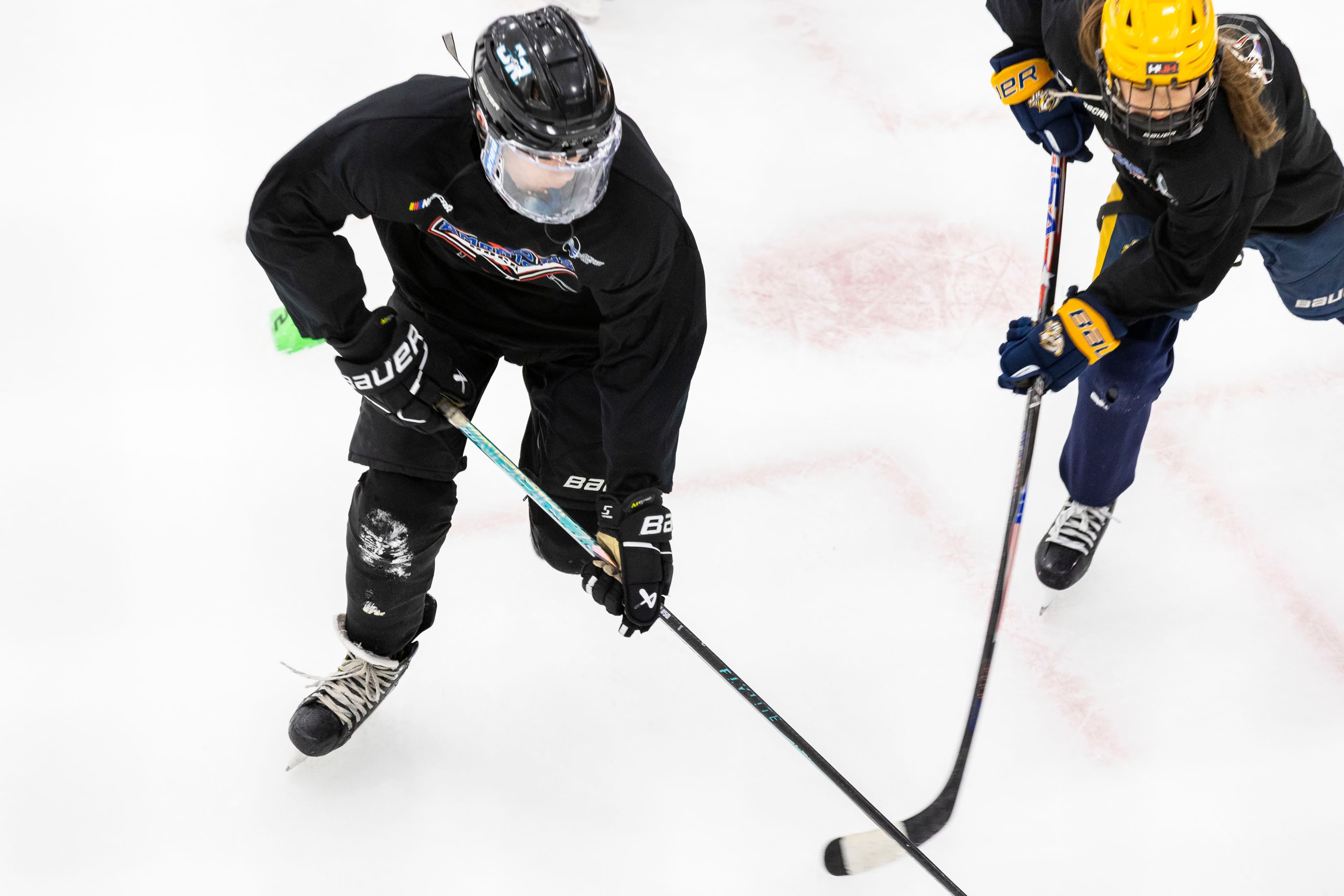 Camper carrying the puck through a drill