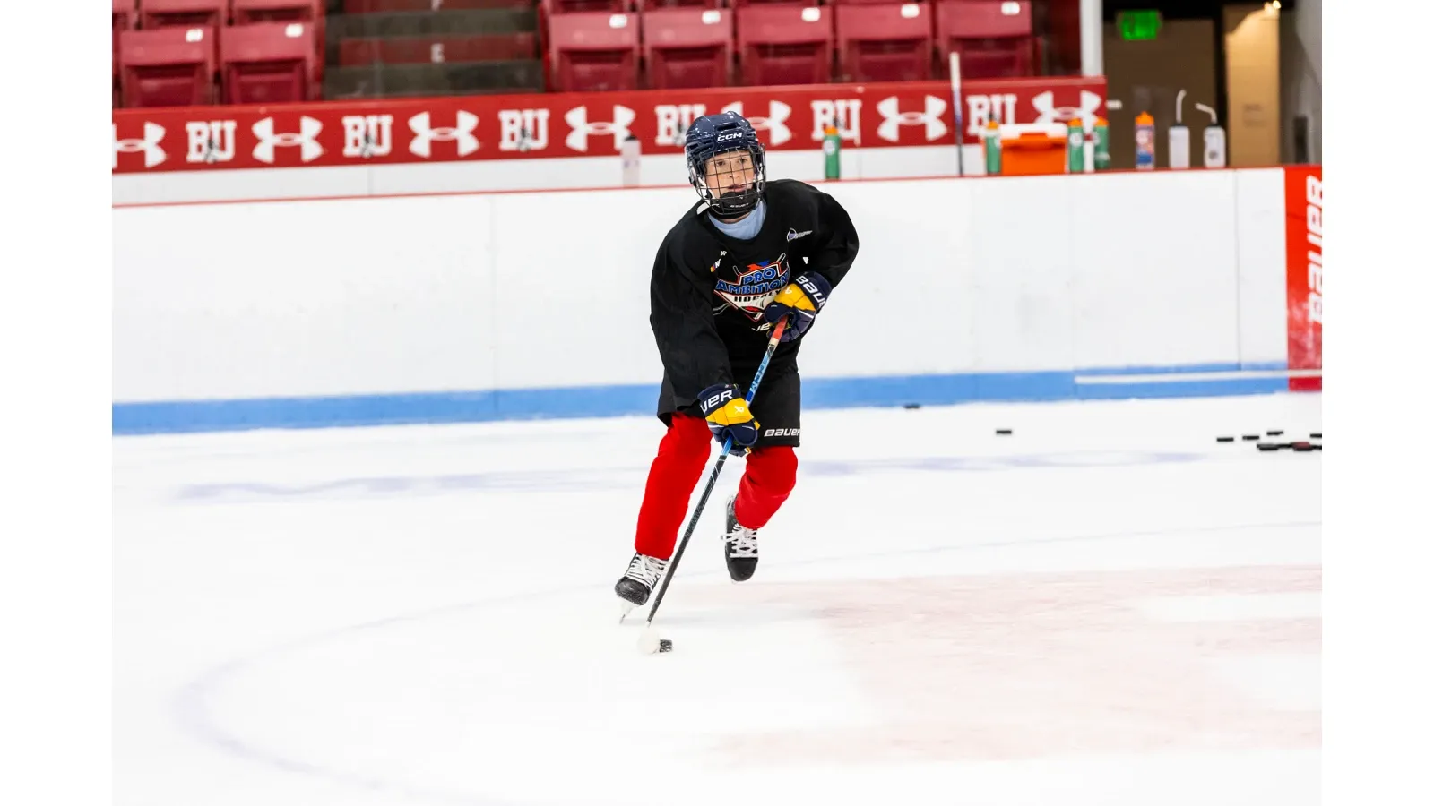 Camper skating with the puck at Boston University