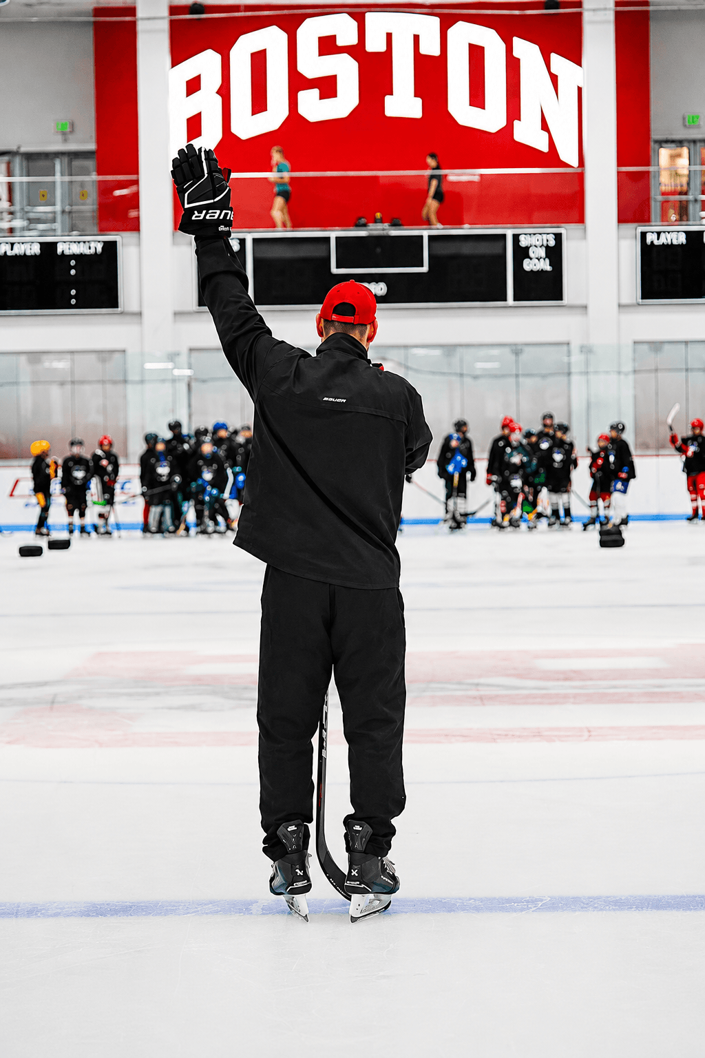 Hockey East camp coach leading a drill on the ice