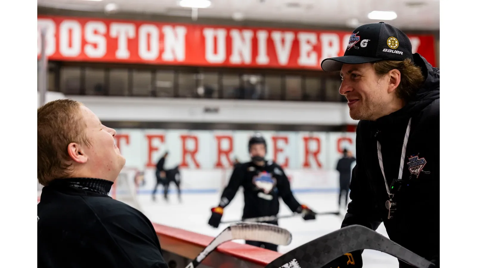 Coach and camper at the bench at Boston University