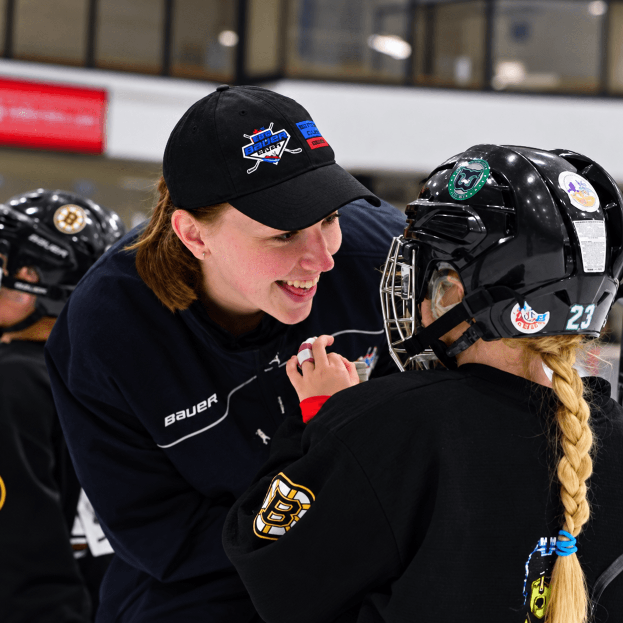 Coach laughing with a girls camp player